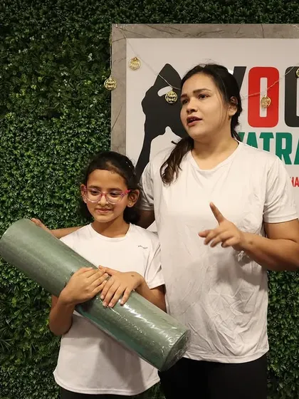 A student receives her very own yoga mat. Having the right tools is an exciting step in any yogi's journey.