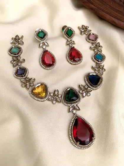 A vibrant Navratan-style necklace. This piece features nine different colored gemstones, making it a colorful and auspicious choice that pairs well with many outfits.