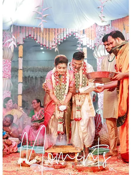 A sacred moment from the wedding ceremony, with the couple participating in a ritual involving holy smoke, captured with an artistic touch.