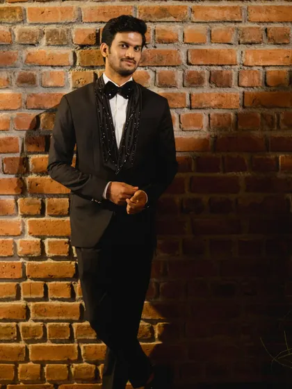This full-length portrait shows the sharp tailoring and clean lines of the custom tuxedo. The fit is designed to be flattering and comfortable, ensuring you look your best for any black-tie occasion.