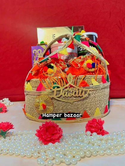 A festive jute basket hamper with a 'Happy Diwali' cutout. It's filled with potlis of dry fruits and other snacks, making it a colorful and cheerful gift for the season.