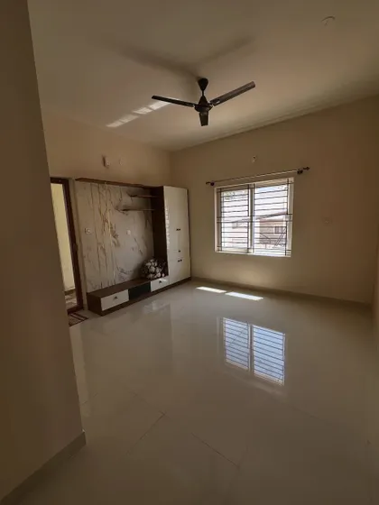 A full view of a living room project from different angles. We painted the walls in a neutral beige that pairs well with the white and wood entertainment unit, creating a warm and modern feel.