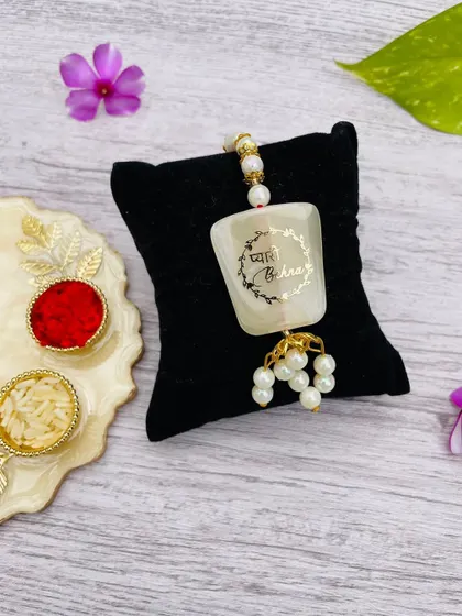 A traditional resin rakhi for a "Pyari Behna" (dear sister), designed as a hanging lumba rakhi.