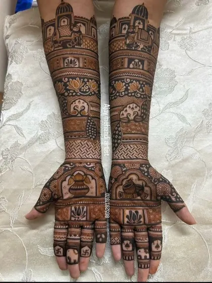 This design is filled with auspicious symbols for a bride. It includes kalash pots, elephants, lotus flowers, and a swastika, all beautifully arranged.