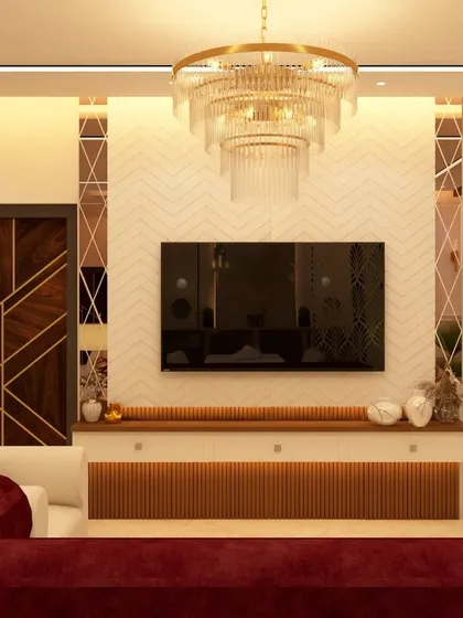 This living room combines classic and modern elements, with a plush red sofa adding a bold splash of color. The TV unit is set against a chevron-patterned wall, with a grand crystal chandelier serving as the room's luxurious centerpiece.