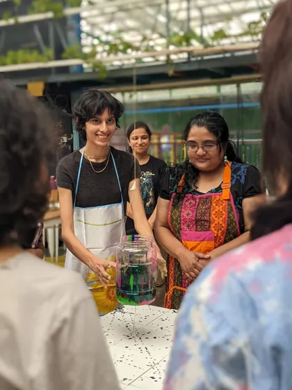 A group of participants enjoying a playful, messy art session. Our sense of joy and belonging is a beautiful form of resistance.