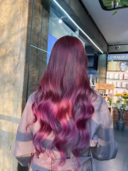For those who love a pop of colour, we created this stunning red-violet ombre. The colour melts from a deep violet at the roots to a vibrant magenta at the ends, showcasing our creative colouring skills.