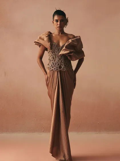 Here, I combined a corded corset with dramatic, ruffled shoulders and a draped skirt. The corset provides the structure, allowing the sculptural sleeves to make a bold, unapologetic statement.