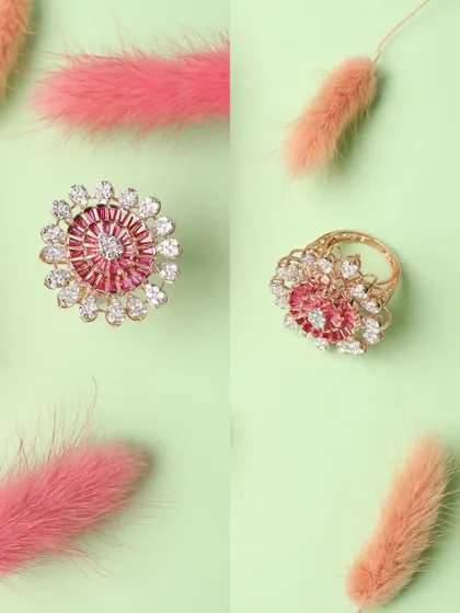 A vibrant and playful flat-lay of a pink floral ring. The use of colorful feathers against a pastel green background creates a fun and eye-catching composition.