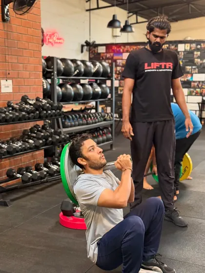 The coach-to-member ratio is key. Here you can see our coaches providing on-the-floor assistance, correcting form during weighted sit-ups and hip thrusts, and ensuring every member gets the attention they need.