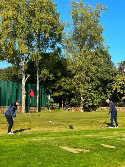 Two golfers work on their putting, a crucial part of the game.