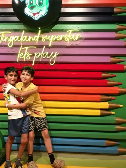 Friends who play together, stay together. Two buddies share a hug in front of our signature colorful pencil wall.