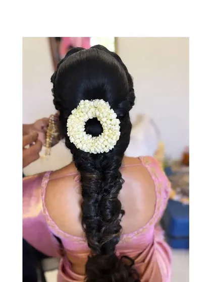 A textured, slightly messy braid with a simple jasmine gajra, offering a softer take on the traditional style.