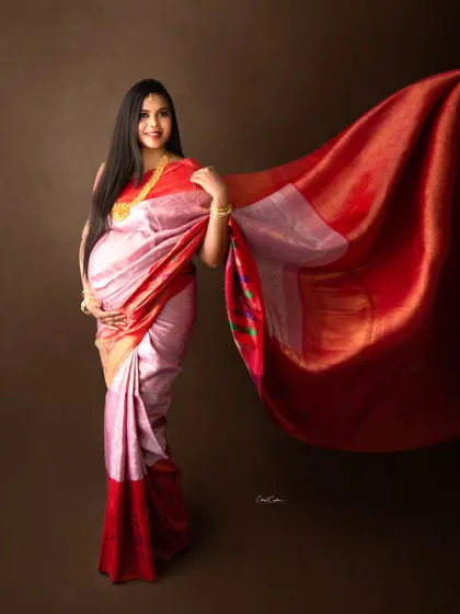 There is a unique grace in a traditional maternity photoshoot. This stunning mom-to-be wears a classic silk saree, and we captured the fabric in motion to create a dynamic and elegant portrait that celebrates her heritage.