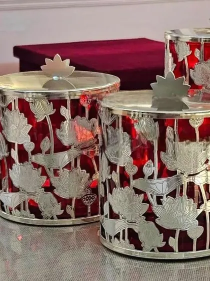 I love the contrast in this piece. These jars feature a silver-plated lotus cutout design over a rich red glass, creating a vibrant and luxurious look.