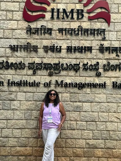 A duplicate of 52 and 55, a photo in front of the IIMB sign.