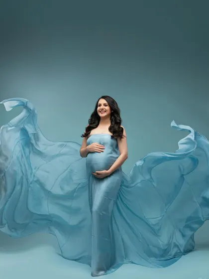 The full, glorious sweep of the blue gown. This wide shot shows the incredible drama and beauty we can create with fabric and light.