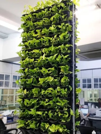 Even a structural pillar can become a point of interest. This vertical garden wraps around a column in an office, maximizing green space without taking up any floor area.