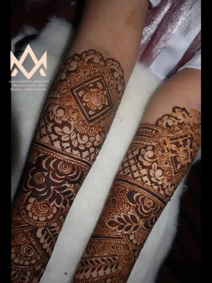 A close-up of an engagement bride's mehendi, showing the intricate details on the forearm.