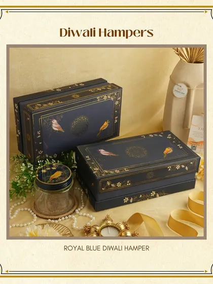 The "Royal Blue" Diwali Hamper is designed to impress. These book-style boxes feature a beautiful bird motif and gold detailing, offering a unique and regal presentation.
