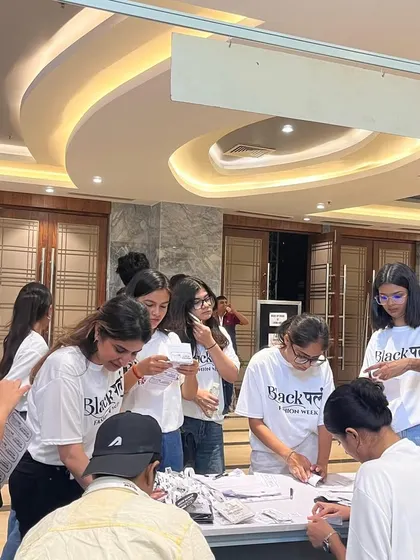 Our students managing the registration desk at Black Pearl Fashion Week, learning about event logistics and coordination.