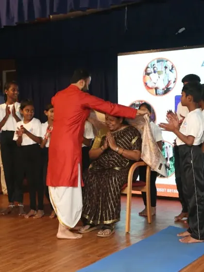 A special moment during our anniversary celebration where we honored the teacher of our government school children's yoga program.
