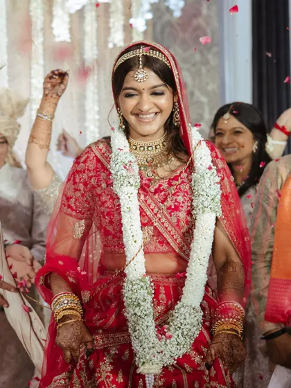Surrounded by loved ones and a shower of petals, this bride's happiness is contagious. Her makeup is designed to last through all the emotional and joyful moments of the day.