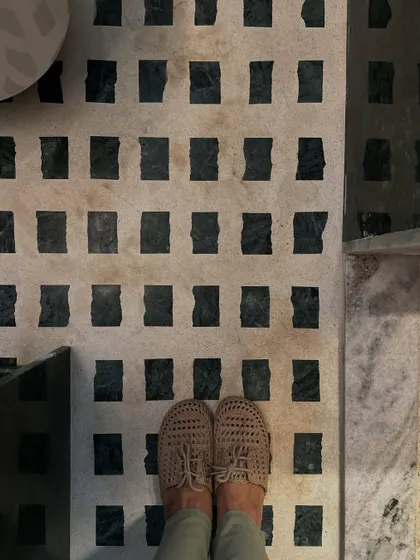 A detail of the bathroom floor, where we created a custom pattern using white marble and offcuts of the Baroda Green Marble. It's a celebration of the wabi-sabi principle of finding beauty in imperfection.