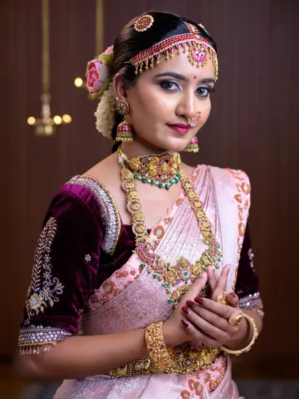 This deep wine-colored velvet blouse features intricate silver floral embroidery, adding a touch of royalty to any bridal or festive saree.