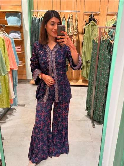 This navy blue and pink printed co-ord set is a great example of festive fusion wear. The peplum top and flared pants are comfortable and chic.