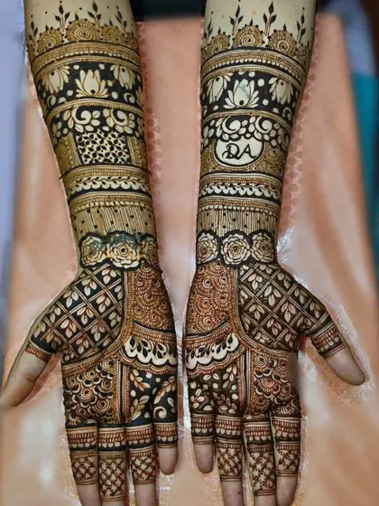 A beautiful design featuring a mix of geometric patterns and delicate rose bands. The personalized initial "DA" is subtly incorporated into the artwork on the arm.