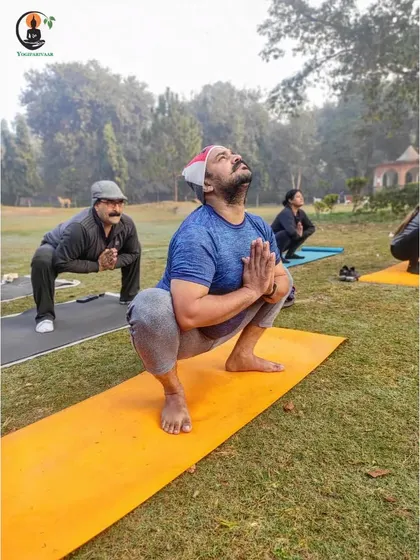 Students practice Malasana (Garland Pose) outdoors, a great squat for opening the hips and strengthening the lower body.