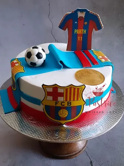 A Barcelona FC-themed cake for a football fan, featuring the team's jersey, logo, and a scarf.