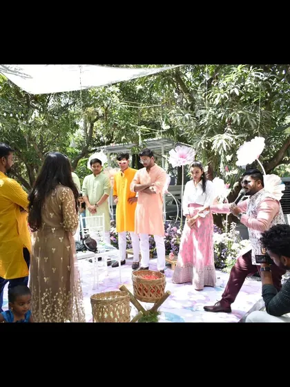 Explaining a game to the guests at a Haldi. I use fun activities to bring the two families together.