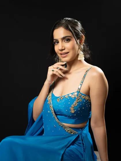 A detailed shot of the embellished bustier and my confident smile.
