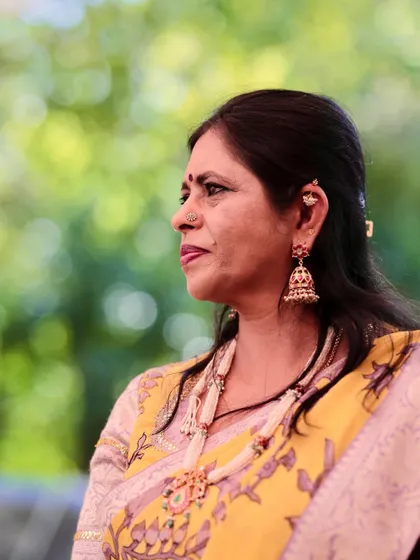 A side profile showing the detail of the blouse and the handcrafted pearl necklace. I believe in creating a complete look, from the outfit to the accessories.