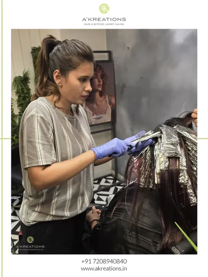 A behind-the-scenes look at our stylist applying foils for a highlight service, showcasing the precision and technique that goes into every color job.