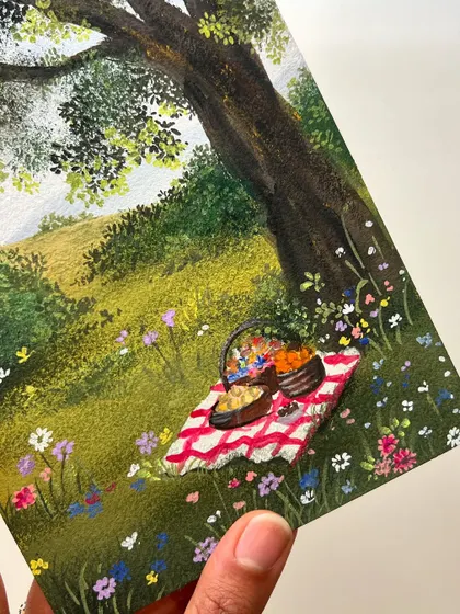 A close up of the picnic basket and blanket from my gouache painting. I enjoyed painting all the tiny flowers in the meadow.