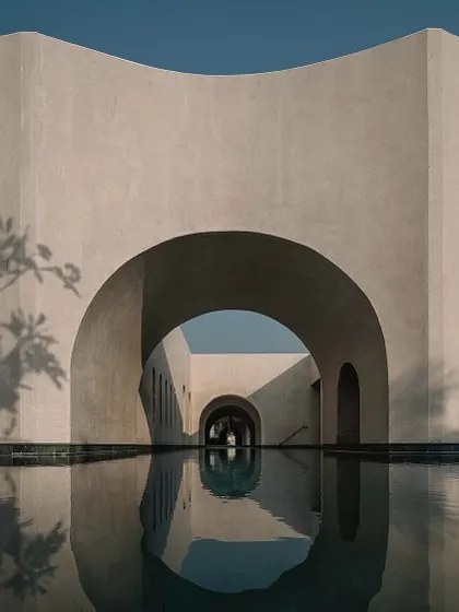 Our design for the Dua Villa in Alibag captures the dialogue between monumental form and the natural elements. The structure's arches are reflected in the tranquil water, creating a composition of rhythm and silence that defines the home's serene atmosphere.