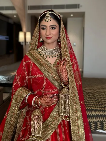 For Agrima, we chose a classic and elegant look. A bold red lip, clean winged eyeliner, and a natural, glowing base created a look of understated sophistication for her wedding day.