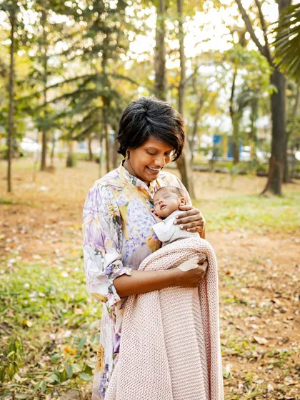 A mother's warm embrace during a golden hour session. The beautiful light and genuine emotion make these outdoor family portraits so special.