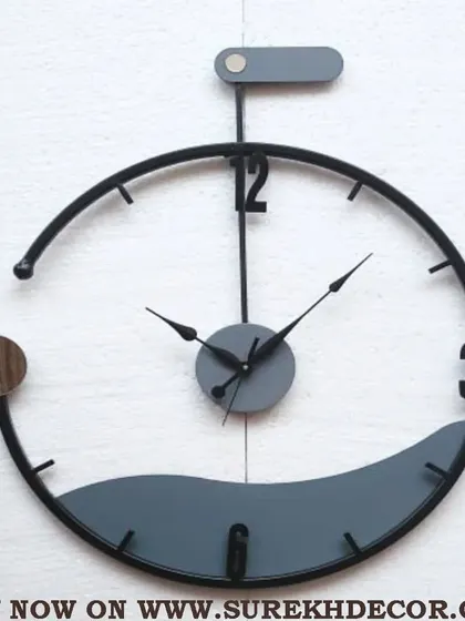 A truly unique designer piece, this wall clock features a semi-circular frame with a wave-like bottom element. The grey and black tones with a touch of chrome create a sleek, contemporary, and artistic timepiece.