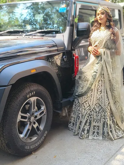 A full-length view of the green and silver lehenga. The intricate work and beautiful flare make it a stunning choice for any event.