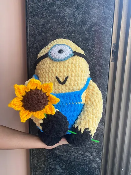 Another look at the plush Minion doll. The texture of this yarn is incredibly soft, making it a perfect sensory toy or a comforting friend.
