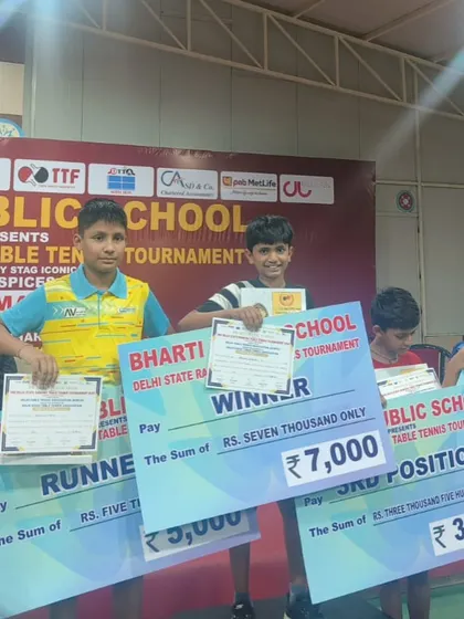 Arunim Agarwal, winner of the U-13 Boys category, holding his prize money cheque at the Delhi State Ranking Tournament. We celebrate our players' success and the rewards they earn.