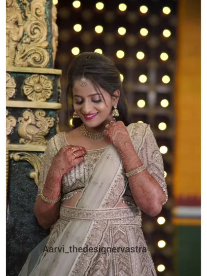 A happy client looking gorgeous in a pastel lehenga for her reception. The intricate embroidery and soft color make it a very elegant choice.