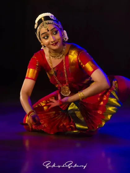 A seated pose of contemplation from my performance at the Natyanjali Festival 2023. The lighting highlights the rich colors of the costume and the introspective mood of the piece.