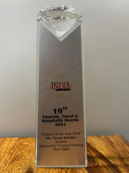 A close-up of the 'Caterer of the Year 2024' trophy from Hospitality India. This award holds a special place in our office.