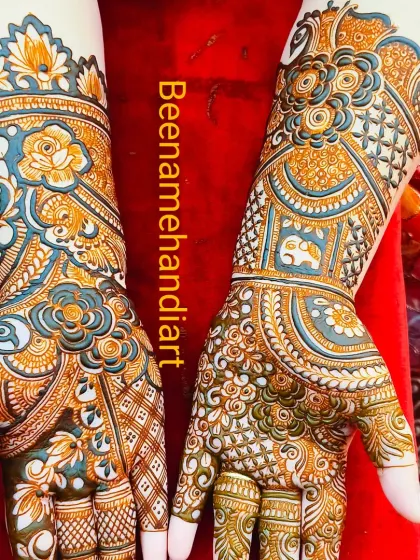 A stunning and colorful design. The use of different shades of henna creates a beautiful effect, especially with the floral and elephant motifs.