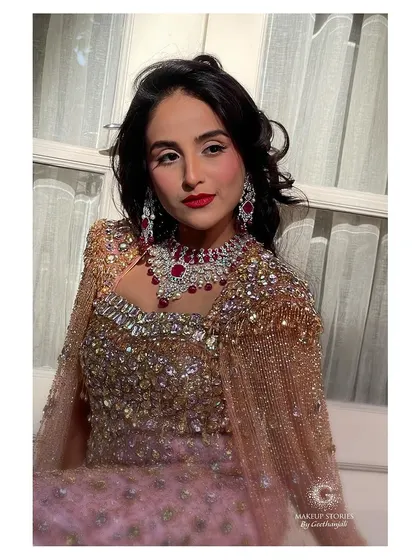 A close up of the Hollywood glamour look. The makeup is flawless, with a focus on radiant skin and a perfectly applied red lip, creating a look of pure sophistication.